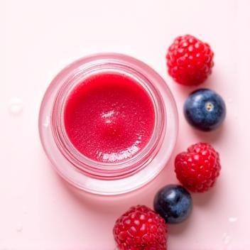 Berry Lip Treatment in clear container with berries